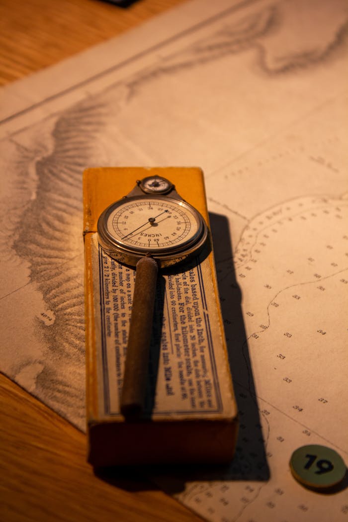 Close-up of a vintage spherometer resting on a nautical chart, creating a classic vintage feel.