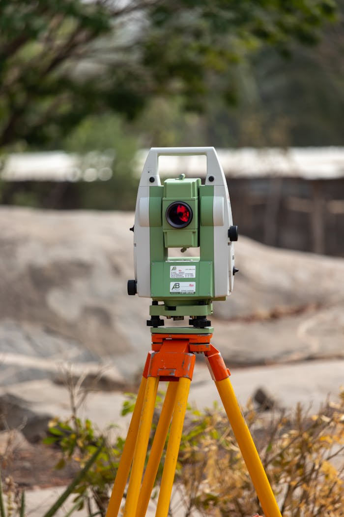 A surveying theodolite set on a tripod outdoors in Dassa, Benin, ideal for civil engineering projects.